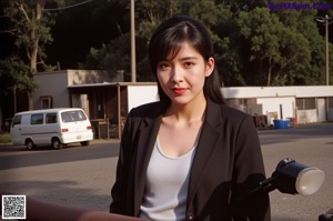 A woman in a white top and pink panties leaning against a window.