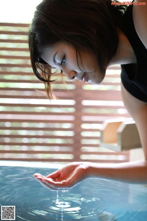 A woman wearing a white bra and a black shirt.