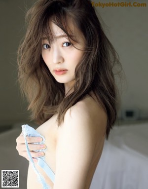 A woman in a blue lingerie posing for a picture.