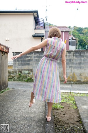 A woman in a blue dress posing for a picture.