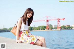 A woman in a white tank top and denim shorts posing for a picture.