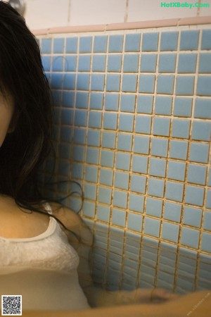 A woman sitting on the floor in a room.