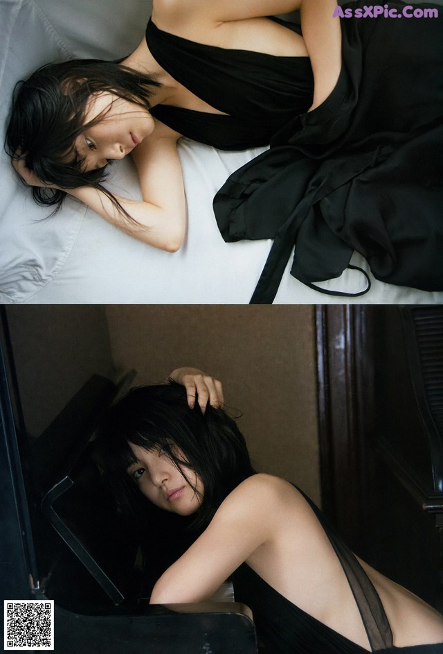 A woman in a black dress laying on a bed.