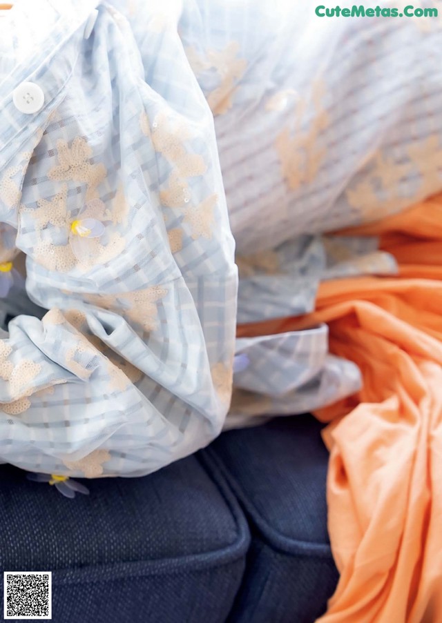 A pile of clothes sitting on top of a couch.