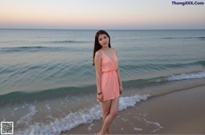 A woman in a blue bikini standing on the beach.