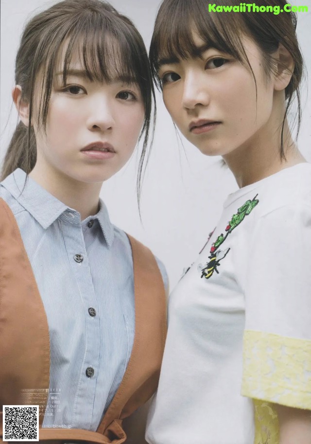 A couple of young women standing next to each other.