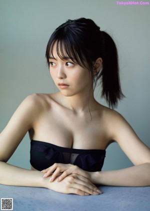 A woman sitting on top of a wooden table.