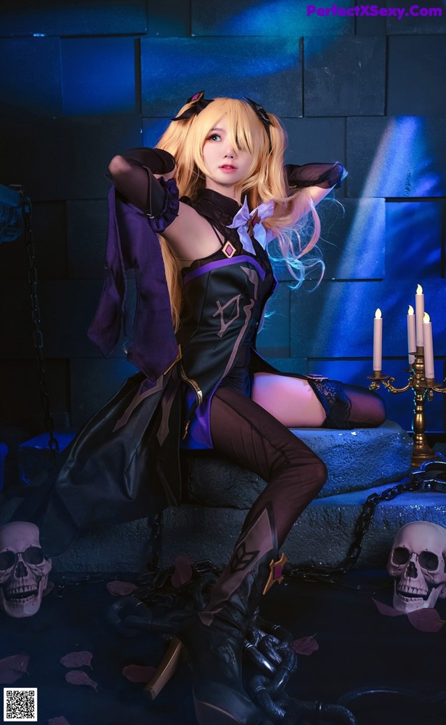 A woman in a black and purple outfit sitting on a ledge.