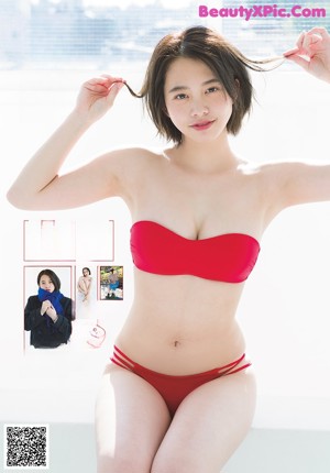a woman in a yellow shirt and white panties posing for a magazine