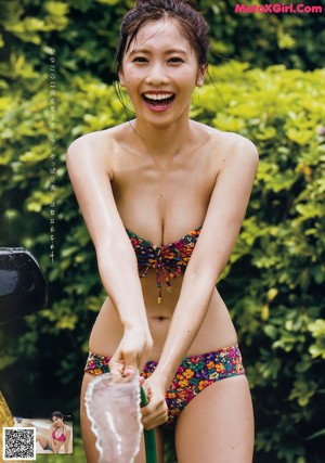 A woman in a bikini standing on a beach.