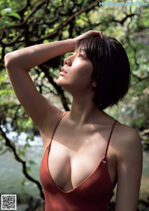 A woman in a gray bikini standing on a beach.