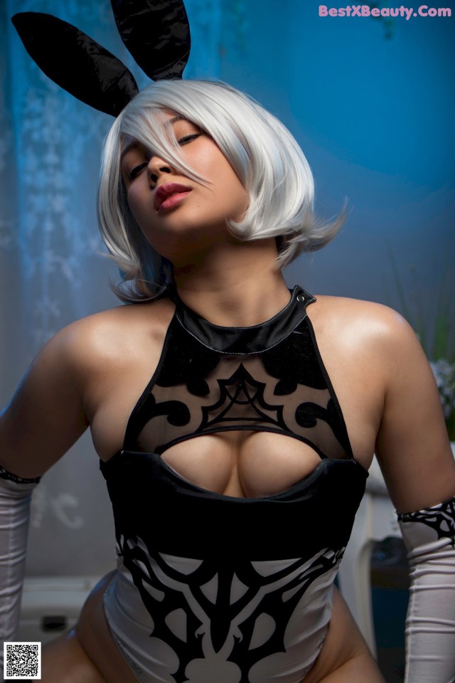 A woman in a black and white outfit with bunny ears.